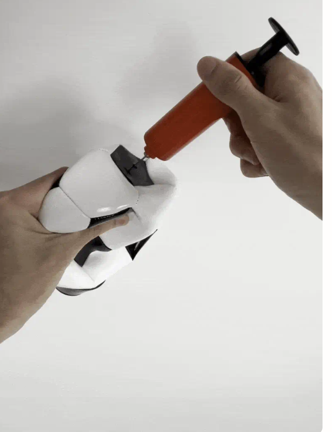 Inflating the Kickpal ball with the included hand pump